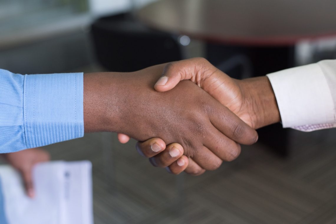 shaking hands after investment agreement